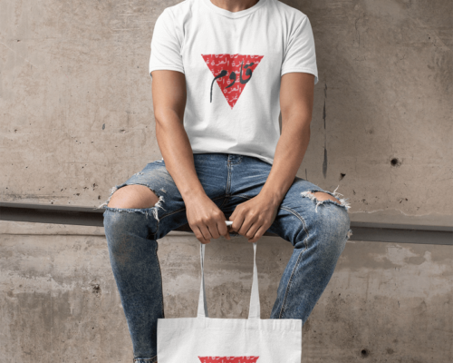 t-shirt-mockup-of-a-bearded-man-with-a-tote-bag-sitting-on-a-concrete-structure-29412